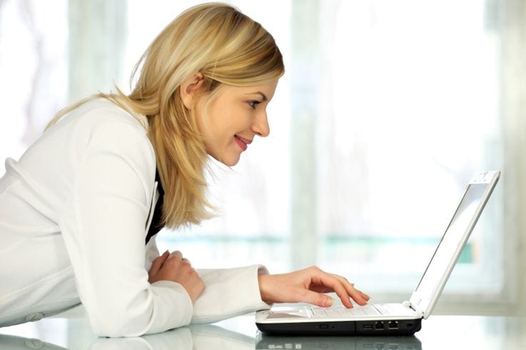 Order documents smiling laptop
