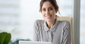 Portrait of smiling confident female boss looking at camera Portrait of smiling beautiful millennial businesswoman or CEO looking at camera, happy female boss posing making headshot picture for company photoshoot, confident successful woman at work